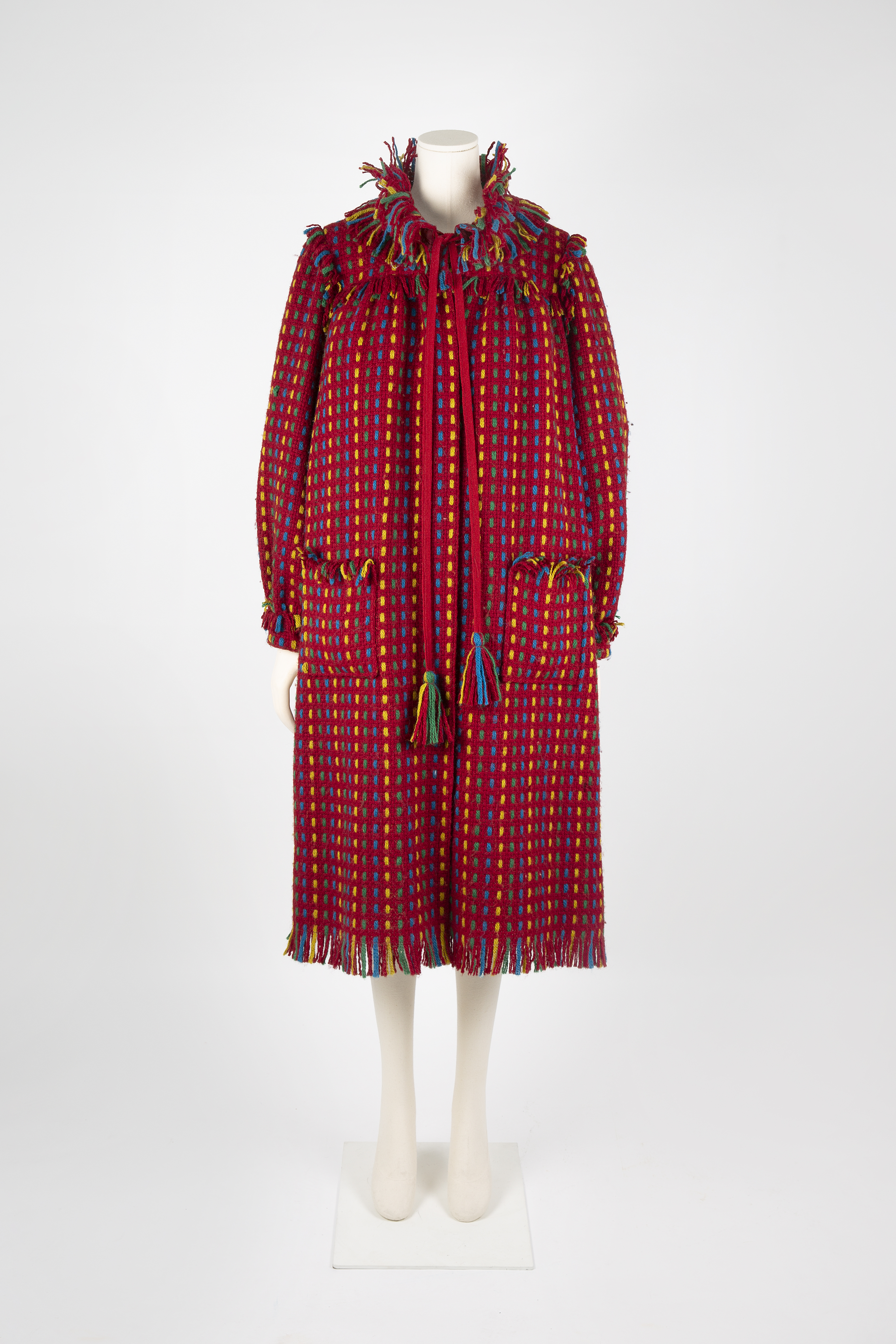 Red wool coat with multi-coloured woven stripe by Bellville Sassoon, worn by Diana, Princess of Wales, 1981