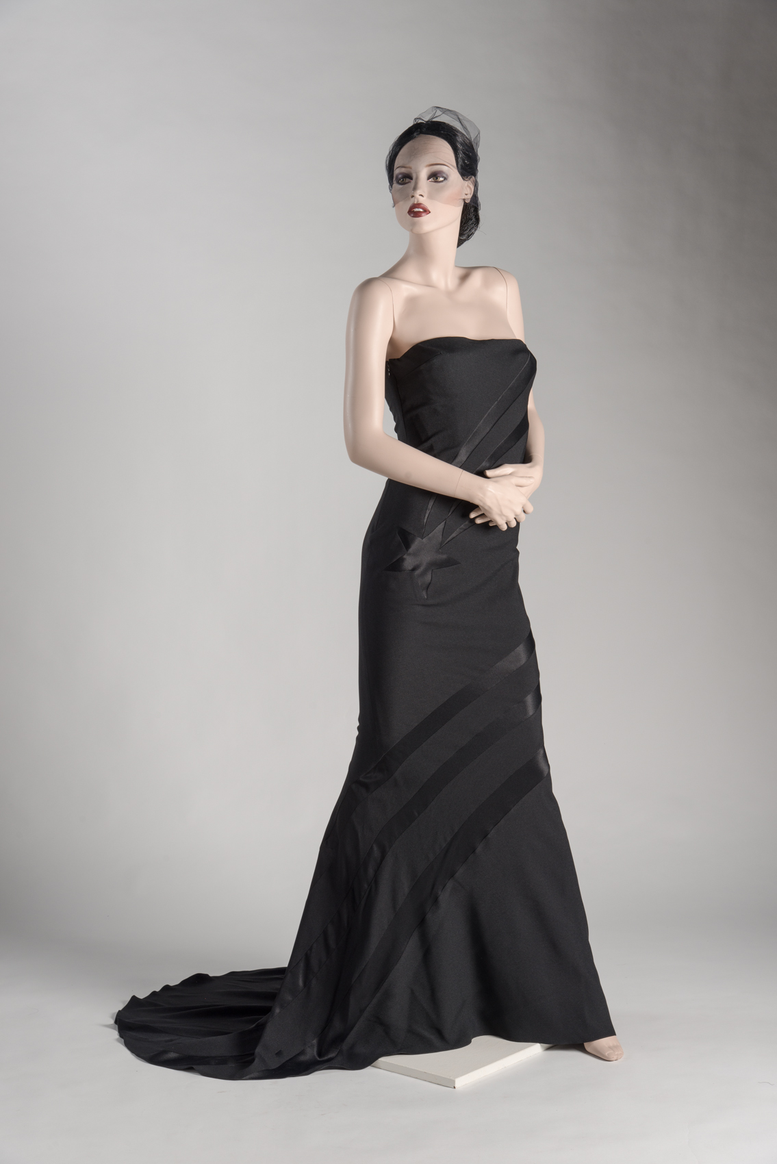 Black silk bias-cut strapless evening dress with starburst decoration by John Galliano