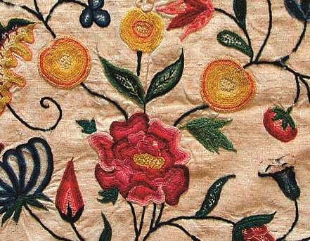 A close-up of some crewel work flowers