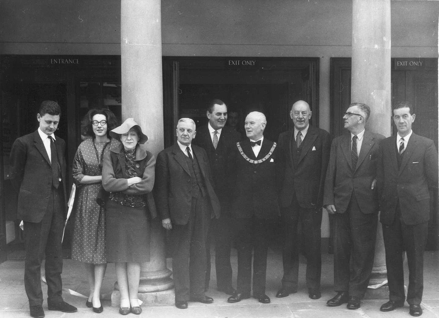 A black and white photograph of people standing outside the Museum of Costume on opening day