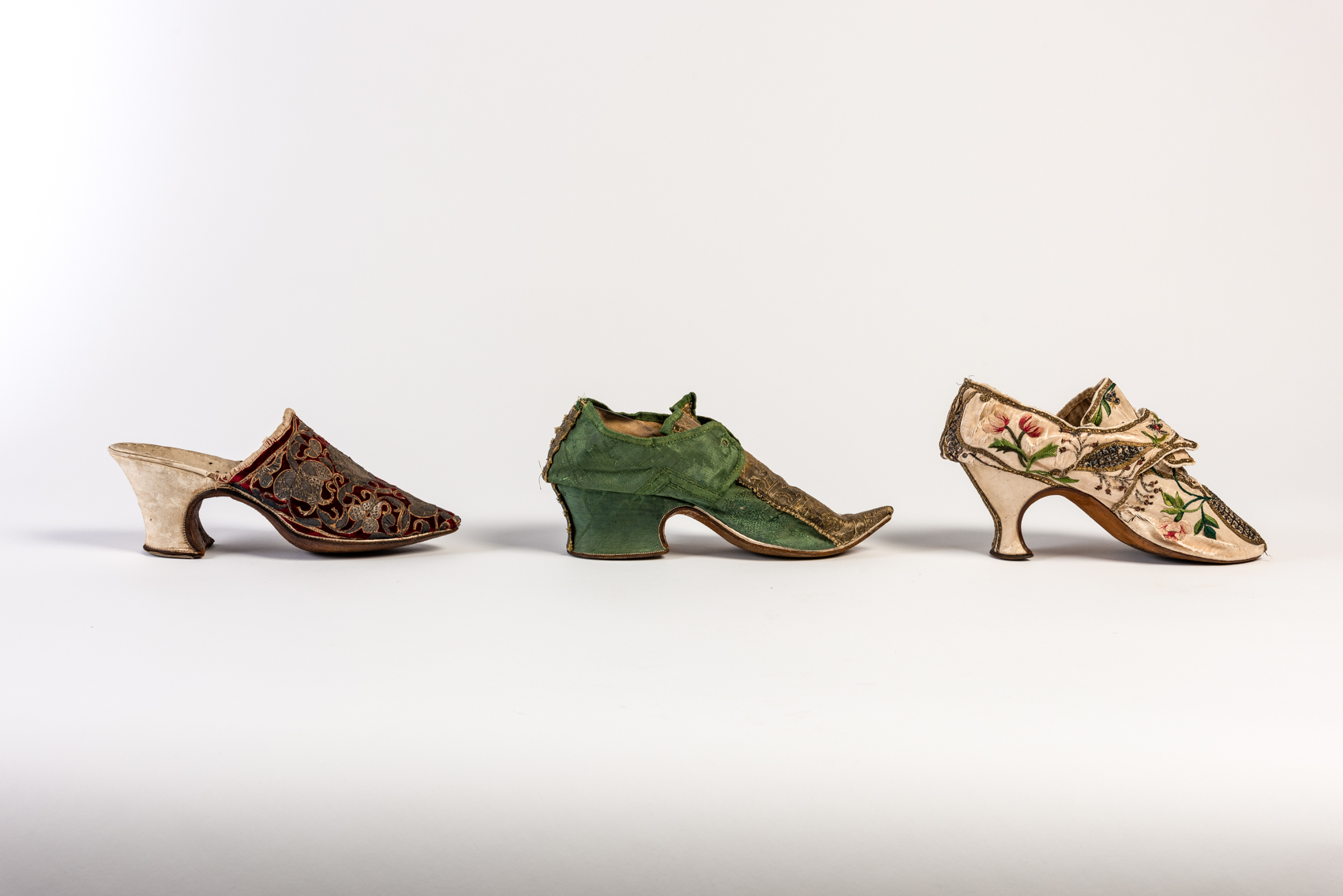Three single shoes in a line from the Fashion Museum Bath collection