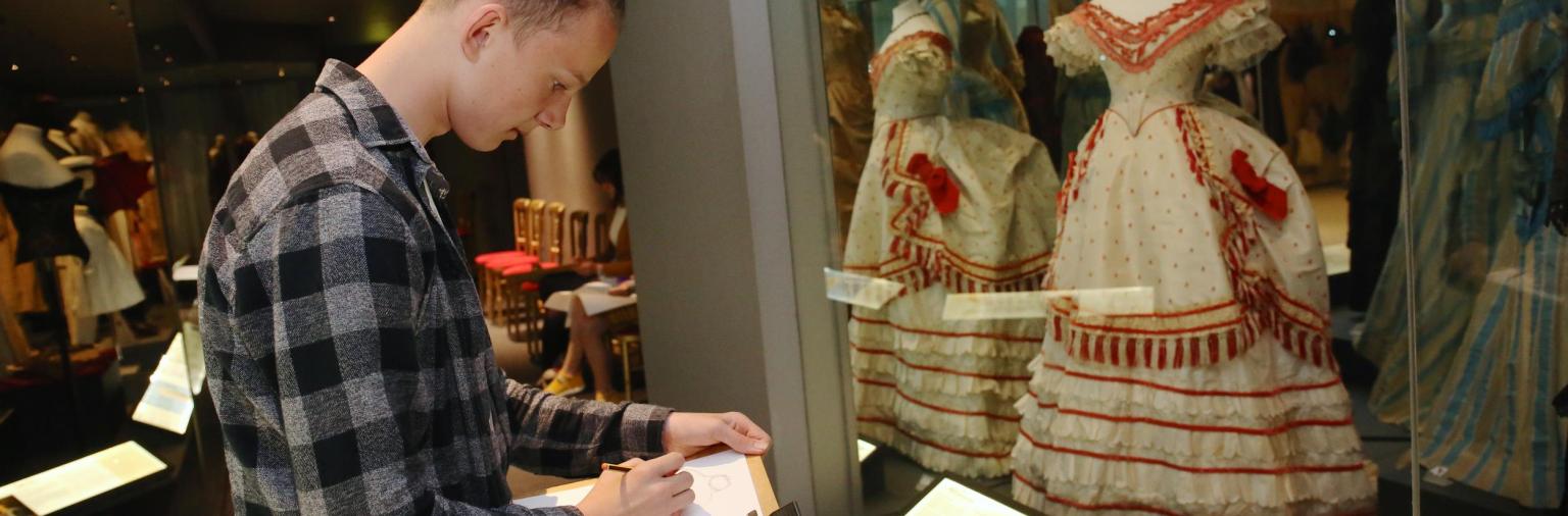 A student sketching in the Museum galleries