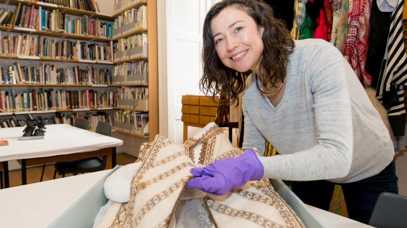 Image: A Fashion Museum curator handling a garment 