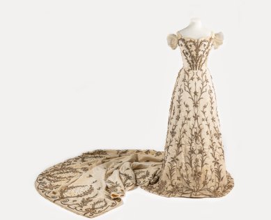 A cream silk court dress by Worth on display in The House of Worth: Inventing Haute Couture at petit Palais, Paris, in collaboration with Galliera, Paris. 