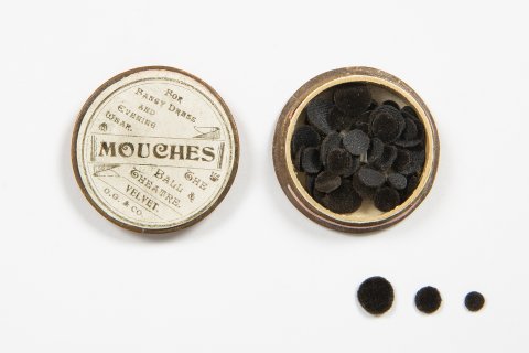 Image: An open pot of black mouches, or velvet beauty spots
