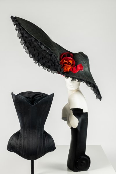 Black corset. Black sculpted ‘bonnet’.
