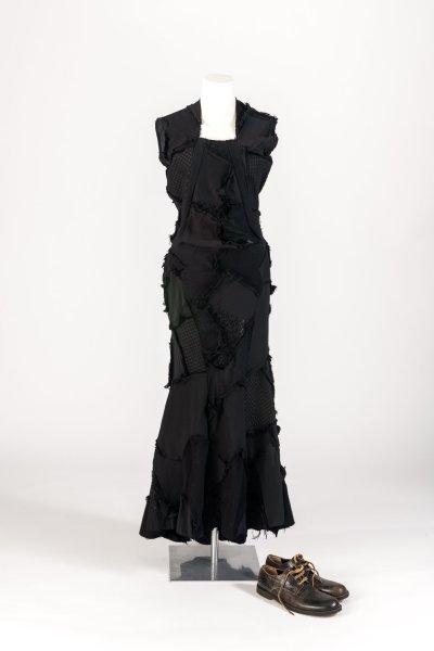 Black patchwork knit and jersey dress and distressed cow-hide brogues