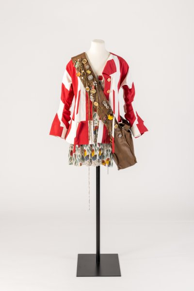 Colourful printed cotton ensemble and jewellery-encrusted shoulder bag