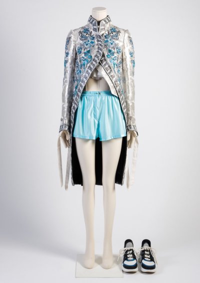 Woman’s silk embroidered redingote style coat, light blue jersey shorts and ‘Archlight’ sneakers