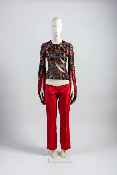 Woman’s red and black brocade tunic with slashed detail and red ‘bumster’ trousers