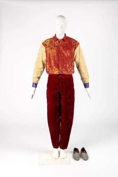 Man’s brocade patchwork shirt, crushed velvet trousers and ikat mules
